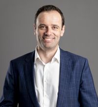 Man in suit smiling, portrait shot.