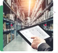 Person holds a tablet in a warehouse and uses it for smart production planning.
