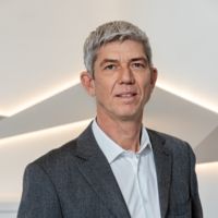 A man in a suit at a CANCOM press event.